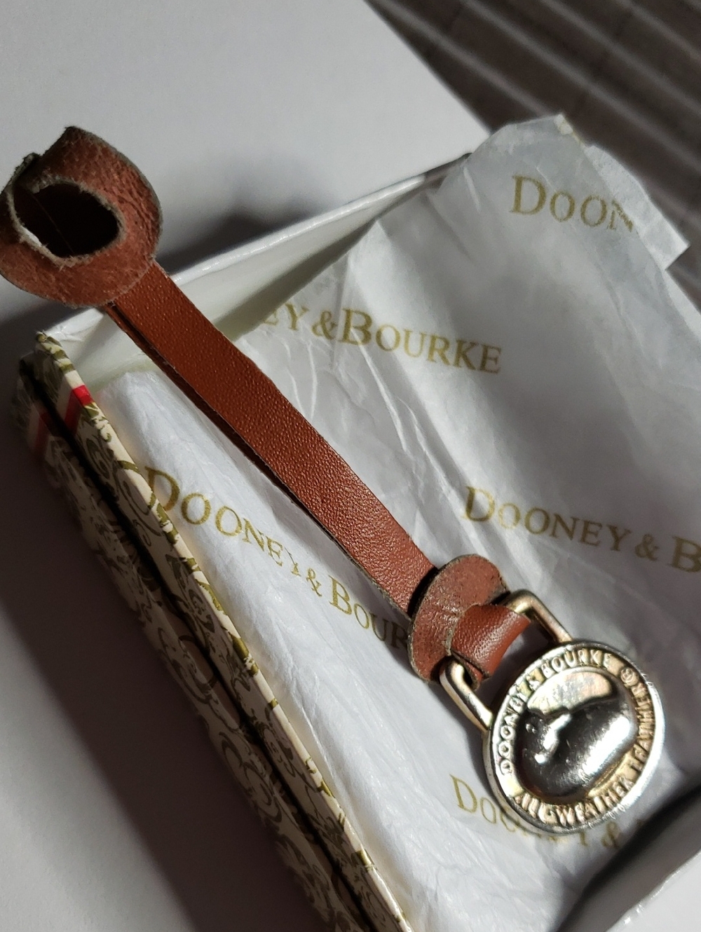 Dooney & Bourke Tan Leather Strap with Brass Medallion